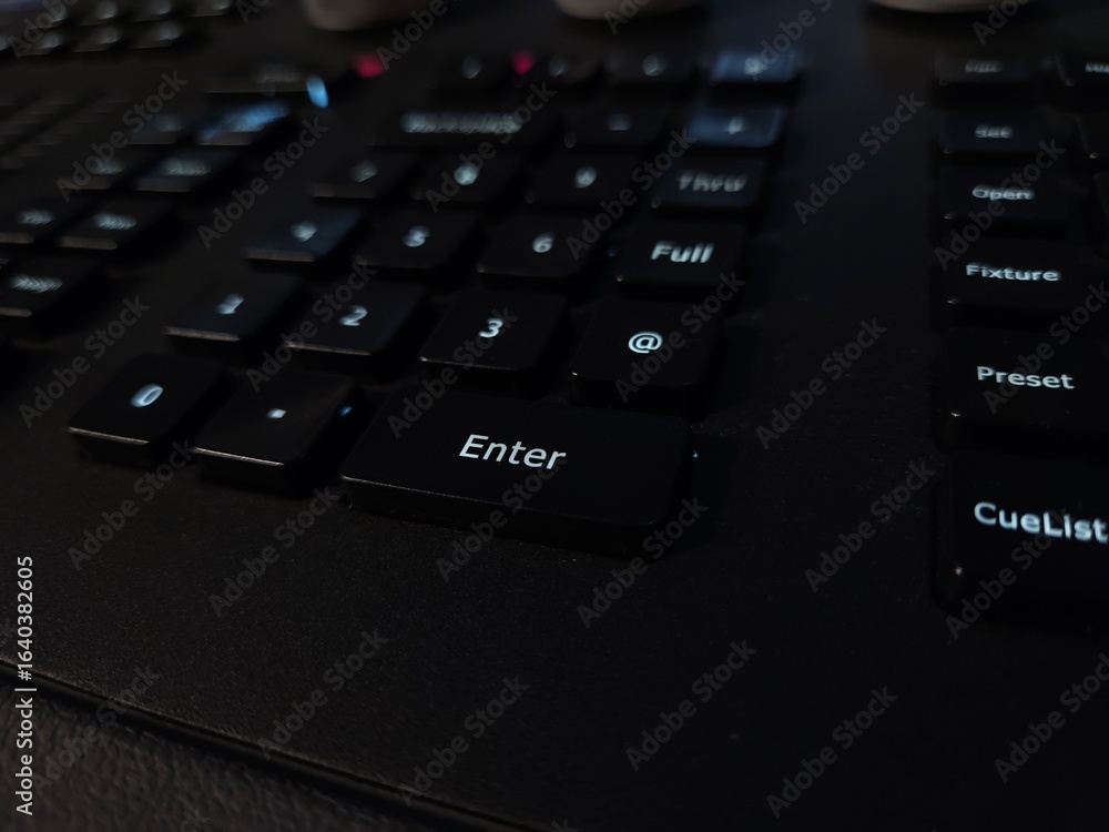 A close-up view of a light light system keyboard, focusing on the numeric keypad and Enter key. A close-up view of a light light system keyboard, focusing on the numeric keypad and Enter key.