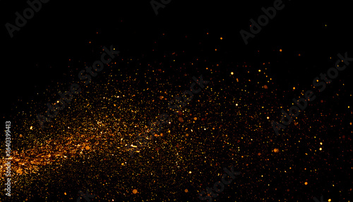 Fiery golden embers and sparks floating in a dynamic explosion against a solid black background