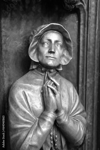 Bronze Sculpture of Woman in Prayer with Rosary in black and white