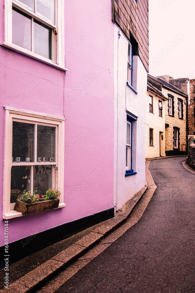 Fototapeta premium Charming narrow street with colorful pastel buildings in a quaint European town