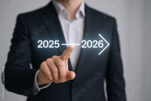 Businessman Pointing at Glowing Arrow Indicating Future Years: 2025 to 2026, Concept of Future