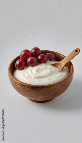 Yogurt in a wooden cup with grapes.