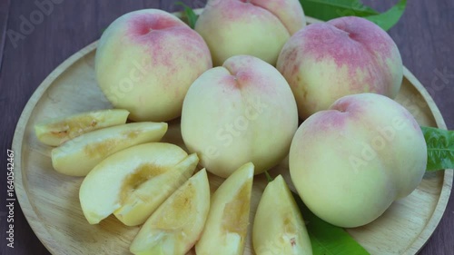Hakuho pink Peach on wooden table,White Peach premium fruit in wooden tray on wooden background