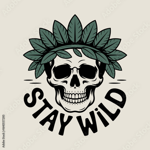 A stylized skull wearing a crown of dark green leaves with the words stay wild in a circular font below symbolizing freedom and nature