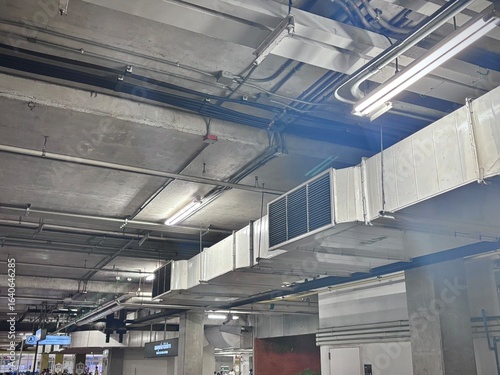 Industrial duct system with ventilation plenum and air grille for factory airflow distribution, ensuring efficient air circulation in manufacturing and warehouse facilities.
