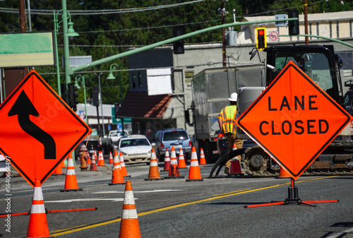 Lane closed sign with traffic and road work