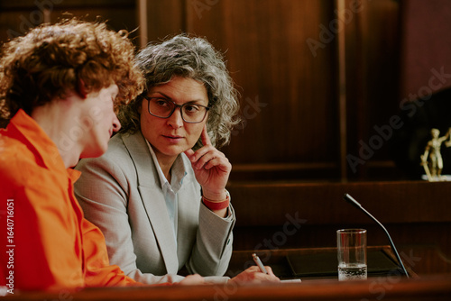 Photos Middle aged Caucasian woman with gray hair and glasses listening attentively to