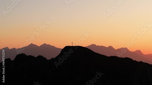 Drone video flying toward to the Italian Alps, capturing the sunrise, mountain peaks, soft morning light, and peaceful alpine scenery.