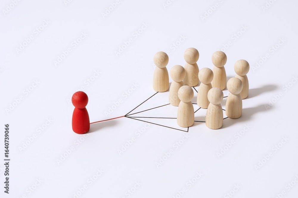 Obraz premium Conceptual Image of Leadership and Teamwork, Featuring Wooden Figures Connected by Lines on a White Background