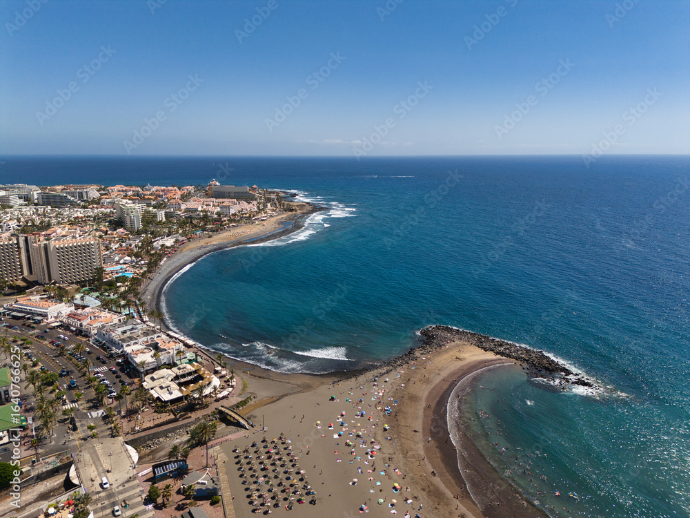 Fototapeta premium Beautiful aerial photo of the coast of Tenerife, the city, the sandy beach and the Atlantic Ocean
