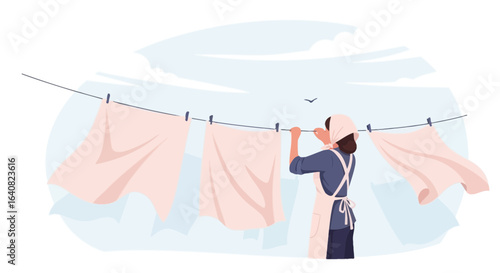 Woman Hangs Laundry to Dry in the Breezy Countryside Atmosphere