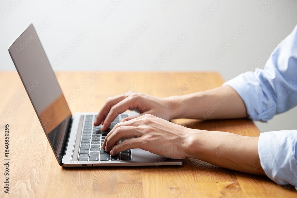 Naklejka premium Typing on laptop keyboard for work or study from home side view stock photo image