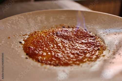 Obraz na plátně French dessert: crème brûlée (being flambéed) in Venice, Italy