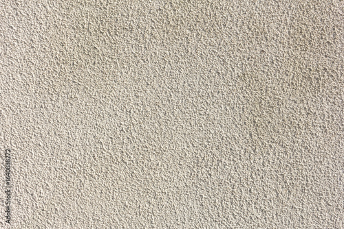 A view of a pebble dash style stucco wall texture, as a background.
