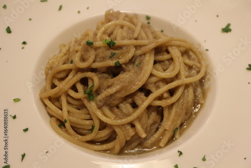 Italian cuisine: bigoli in salsa (bigoli basta with anchovies and onions) in Venice, Italy