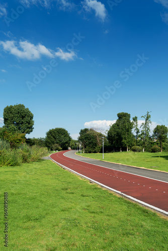 New pathway and beautiful trees track for running or walking and cycling relax in the park