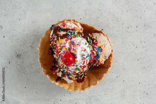 A top down view of an ice cream sundae in a waffle bowl.