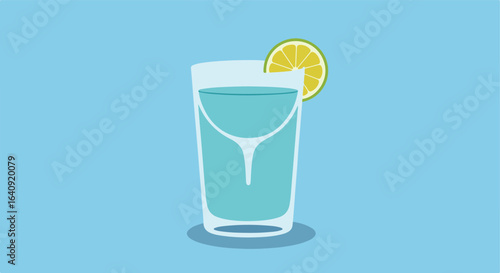 Glass of clear liquid with lime slice on a light blue background