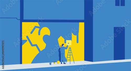 Mural art Artist on a ladder paints over yellow mural in bright blue building