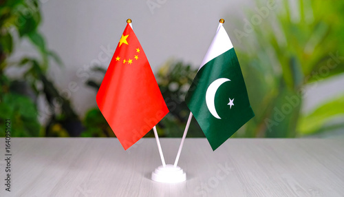 Closeup of China and Pakistan flags with green background