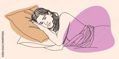 An elegant young woman with a flower in her hair and a towel around her body relaxes peacefully in a spa