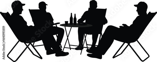 Silhouette of four men sitting in folding chairs around a table, relaxing, drinking, socializing outdoors, casual gathering, evening leisure