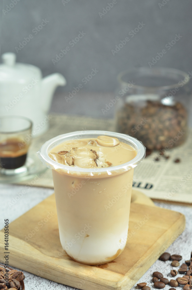 Ice coffee in a plastic cup with brown sugar and ice cubes and beans Ice coffee in a plastic cup with brown sugar and ice cubes and beans