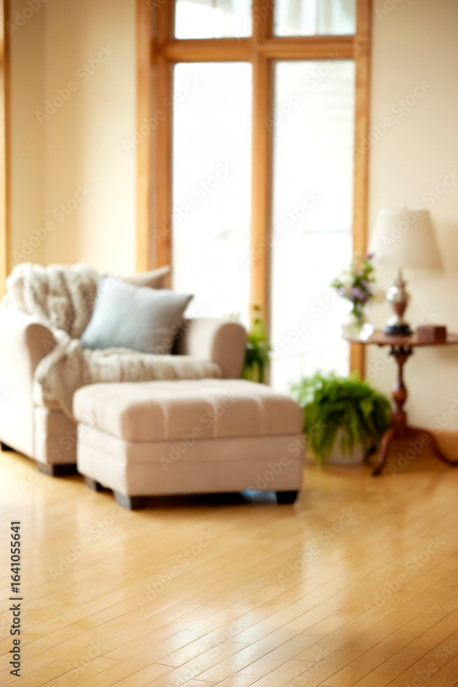 Fototapeta premium Beige armchair with ottoman and blanket by large window with lamp throw