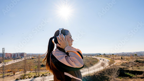 Latin woman runner enjoying music during outdoor exercise