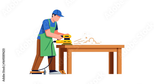 Male woodworker in a green apron and blue cap sanding a wooden table with a power tool.