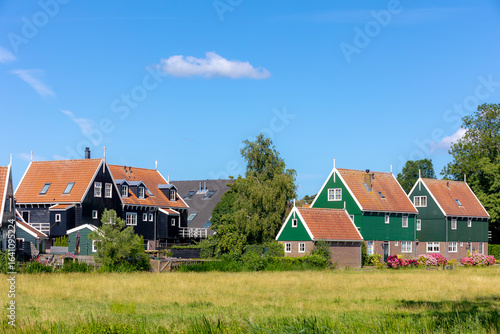 A small town village of Marken in summer, Architecture traditional houses and church under blue sky and white fluffy cloud, The municipality of Waterland in the province of North Holland, Netherlands.