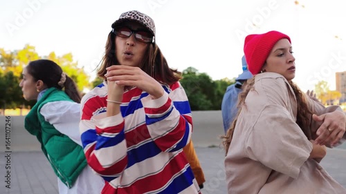 A dynamic group of friends showcasing their energetic dance moves, filled with joy and enthusiasm, creating an infectious vibe while enjoying their time together in a spirited celebration of movement.