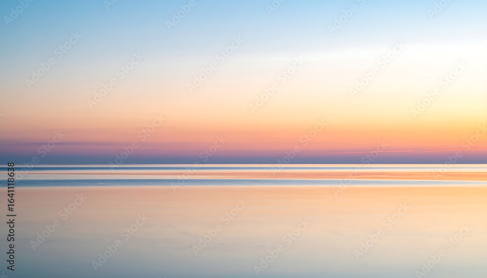 Fototapeta premium Serene Sunset Over Calm Ocean Displaying Soft Pastel Colors.