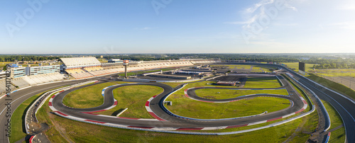 Concord, United States - 28 July 2025: Aerial view of Charlotte Motor Speedway, where the vibrant green infield contrasts sharply with the gray asphalt tracks.