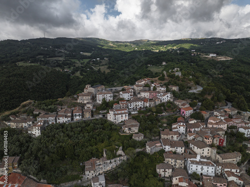 Wallpaper Mural Aerial view of a charming Italian village nestled amongst rolling hills, with terracotta roofs contrasting against the lush green landscape, Morcone, Benevento, Campania, Italy. Torontodigital.ca
