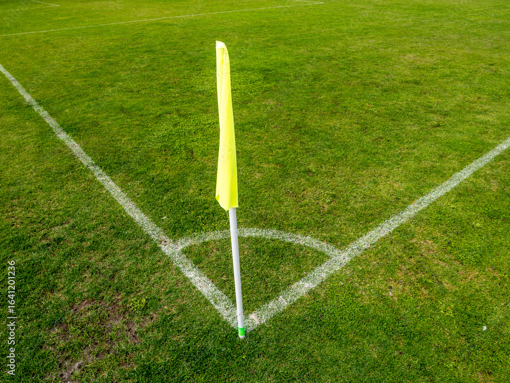Fototapeta premium Yellow corner flag on soccer pitch