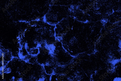 Close-up view of a blue textured wall showing rough patterns and intricate shadow details, offering a visually appealing background texture for versatile creative uses.