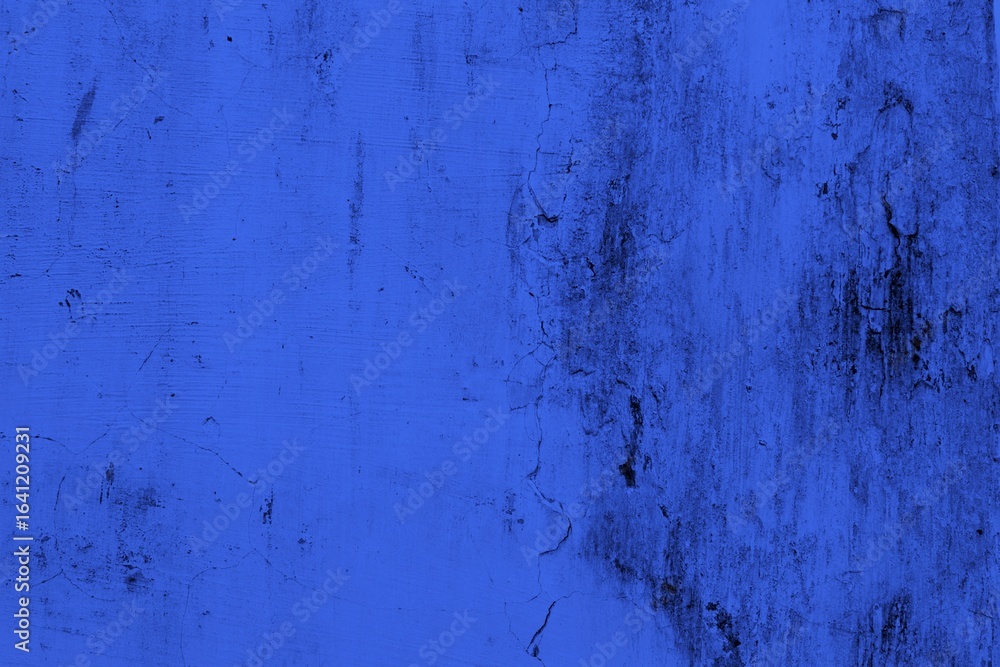 Obraz premium Close-up view of a blue textured wall showing rough patterns and intricate shadow details, offering a visually appealing background texture for versatile creative uses.