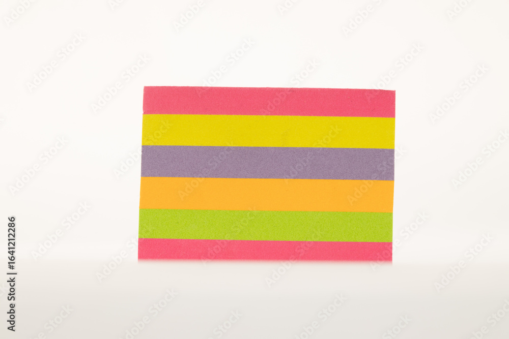 Obraz premium Colorful sticky notes arranged in a stack, isolated on a clean white background