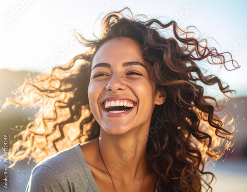 The joy and dynamism of the young woman bursting with laughter dazzles in this photog