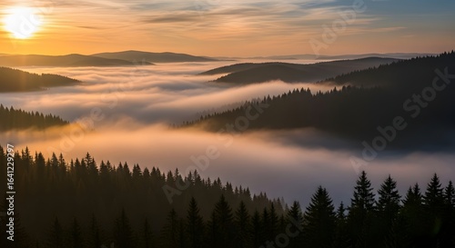 A scenic landscape of mountains covered in fog with a vibrant sun setting in the background sky