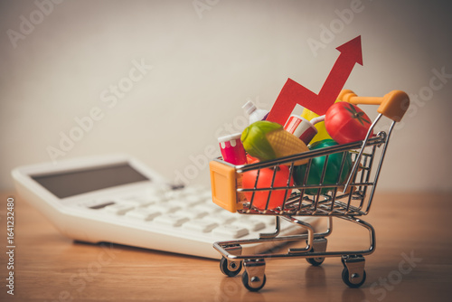 Fototapeta Naklejka Na Ścianę i Meble -  Red arrow growth chart, food, drinks, vegetables, fruits in supermarket trolley. Rising cost of living, food price increase, inflation crisis, war effect to global economic, US tariffs effect concept.