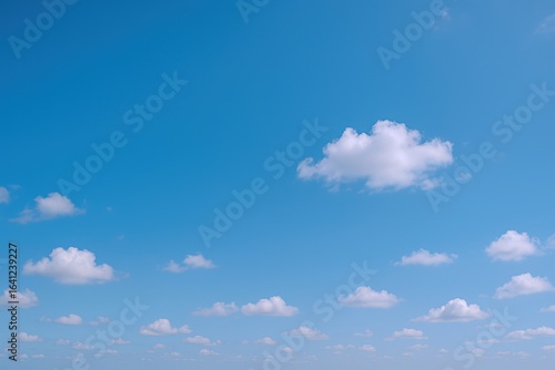 Bright Blue Sky with Scattered Clouds, Perfect for Backgrounds, Wallpapers and Commercial Use