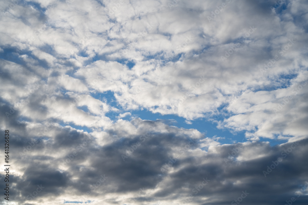 Fototapeta premium Blue sky with grey clouds, abstract cloudy background
