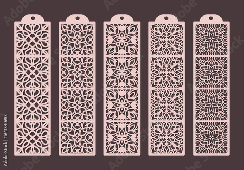 Collection of five intricately designed lasercut paper bookmarks featuring delicate floral and geometric patterns in a soft pink hue vector