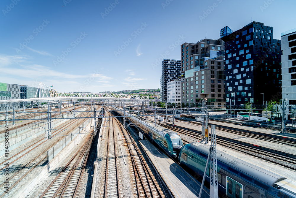 Fototapeta premium Train at Oslo train station, Norway. Modern Barcode district. 