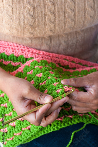 Young Latina woman crocheting