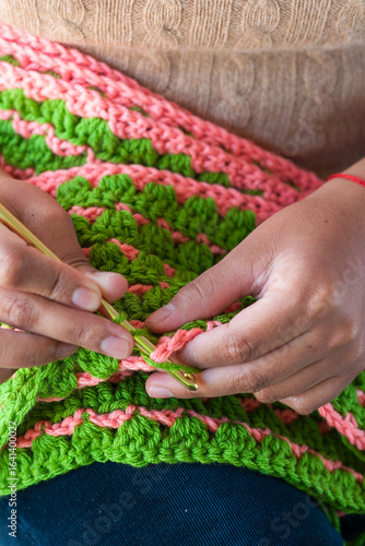 Young Latina woman crocheting