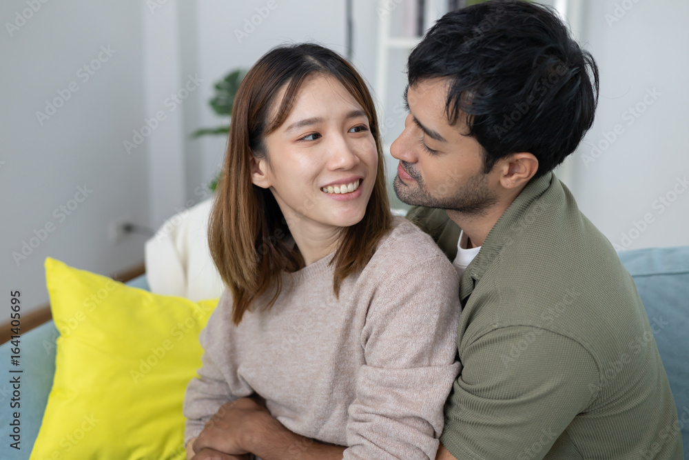 Fototapeta premium couple smile and happy hug each other eyes, cuddling, warm hugs, young love, married couple, warm family. Husband and wife in love so fun in new years eve or valentine day