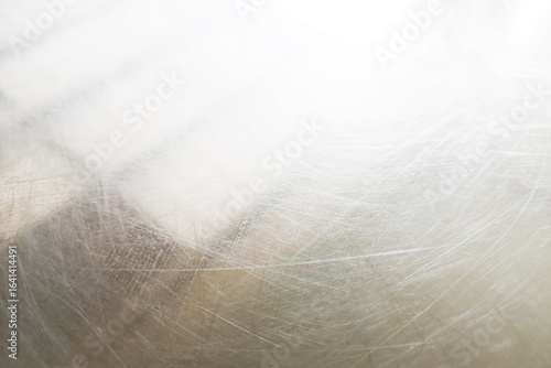 Scratches on the shiny aluminum surface.
